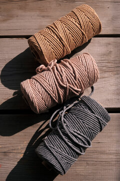 Closeup of colorful cotton rope thread on wooden table. Used to weave mandala totem