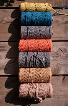 Closeup of colorful cotton rope thread on wooden table. Used to weave mandala totem