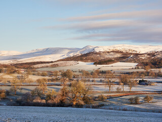 Cumbrian fells covered in snow at sunrise. Kirkby Stephen, Cumbria, UK.