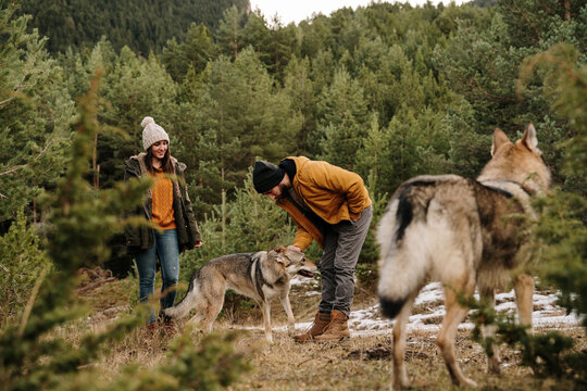 Couple with wolf dogs hiking in the mountain