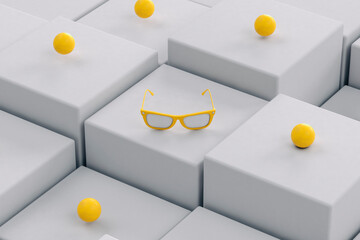 Yellow sunglasses on grey, randomly positioned cubes