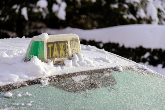 Taxi sign covered with snow