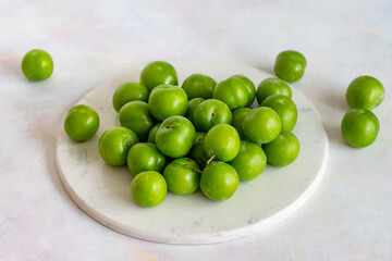 Green plum on a white background.