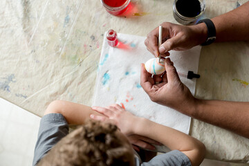 Father and son decorate Easter Egg