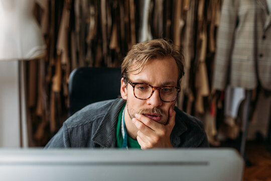 A Man Using a Laptop at Work