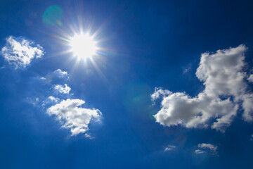 Sunlight in summer with  white clouds on a blue sky background