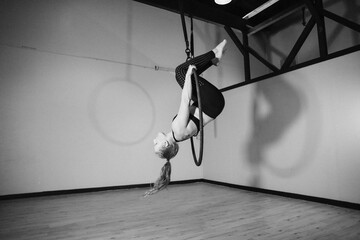 Athletic Aerialist Woman on Lyra Hoop