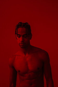 Man Shirtless In Red Room
