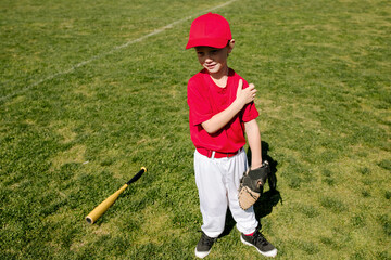 Young baseball player with glove and bat