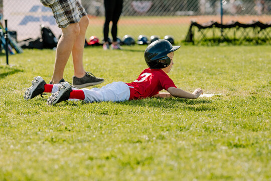 Young runner dives for home plate