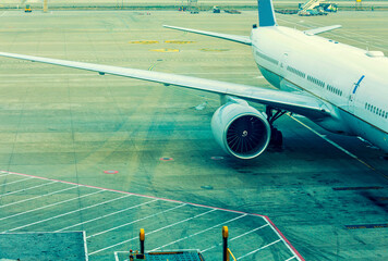 Close up of airplane jet engine parked at an airport apron
