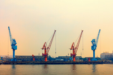 Cranes in blue and orange at an industrial port
