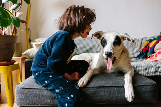 Kid mocking her dog pet yawning