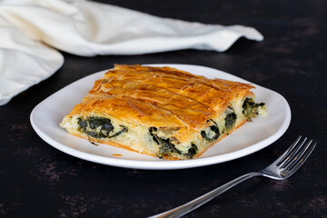 Turkish Spinach Pie on a dark background.