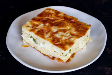 Turkish cheese pie on a dark background.