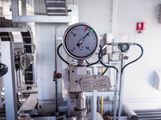 Pressure gauge of measuring instrument close up in industry zone at power plant.