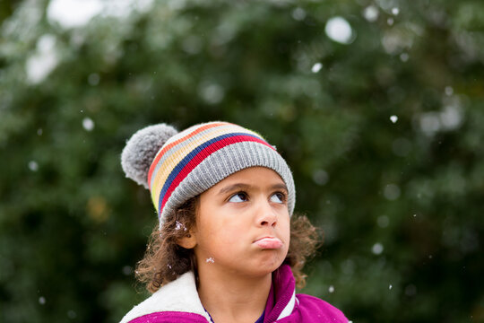 Girl pouts in falling snow