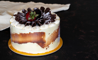 Cake with whipped cream on a dark background