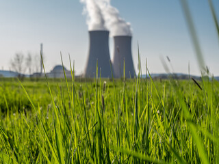 Green grass against nuclear power plant - obrazy, fototapety, plakaty