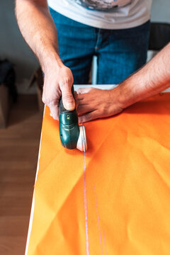 Tailor using rotary cutter in workshop 