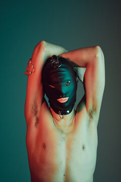 Male slave wearing a fetish mask.
