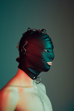 Young male wearing a gimp mask.
