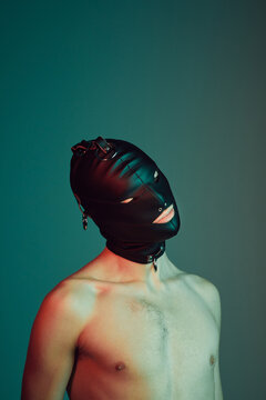 Young male wearing a gimp mask.
