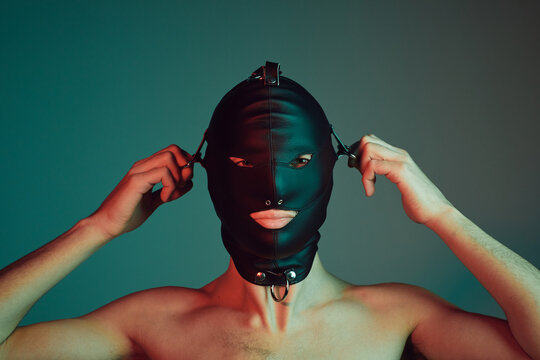 Male slave wearing a fetish mask.