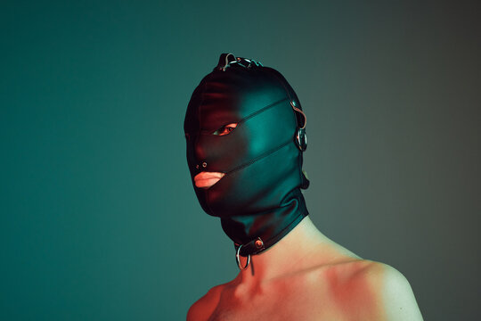 Young male wearing a gimp mask.
