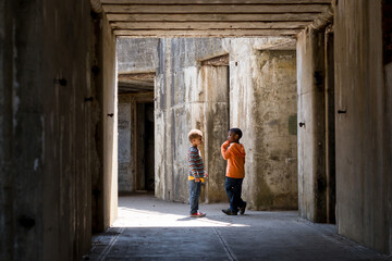Brothers stand in concrete tunnel