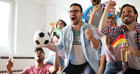 Young group of friends watching sport on television