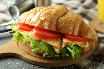 Concept of tasty eating with croissant sandwich, close up