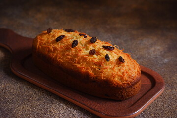 cake topped with cheese and raisins on a plate