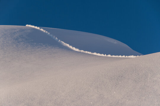 ice formation in snow dune and blue sky