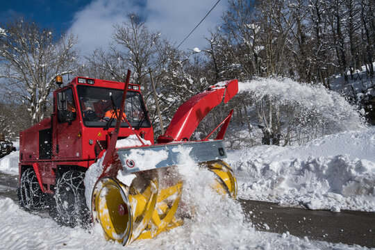 snow blower clearing snow for road