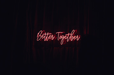 Pink neon text on a dark wall