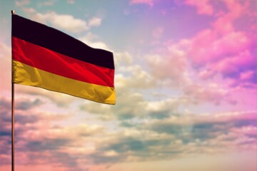 Fluttering Germany flag mockup with the space for your content on colorful cloudy sky background.