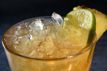 closeup yellow cocktail on dark background