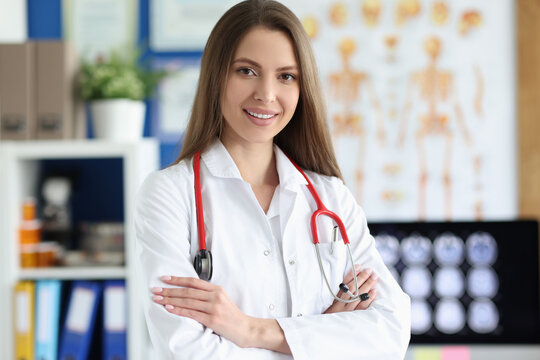 Young woman doctor in uniform with red stethoscope in clinic