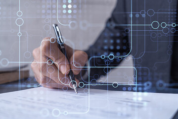 A client in dark blue suit is signing a contract to create a new software to present it in start up...