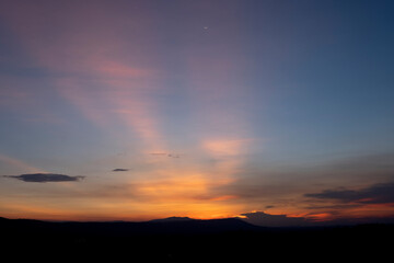 A view of a landscape with a golden evening sky.