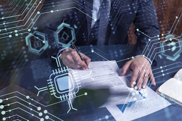 A client in dark blue suit is signing a contract to create a new software to present it in start up conference and gain investments to create a product. Technological graph over the desk.