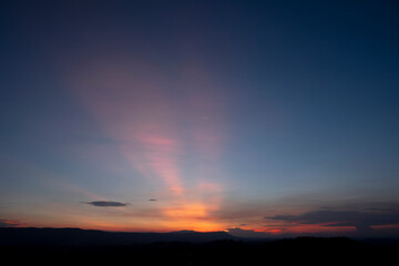 A view of a landscape with a golden evening sky.