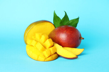 Tasty ripe mango fruit on blue background