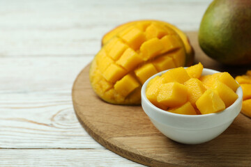 Tasty ripe mango fruit on wooden table