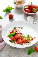 Strawberry granola with greek yogurt, nuts and fresh berries for breakfast