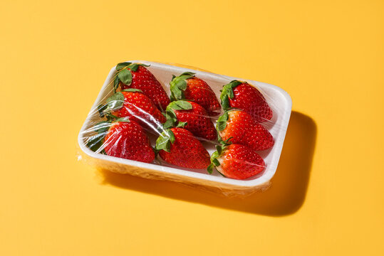 ripe strawberries in a foam tray