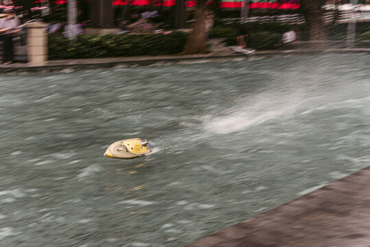 Toy boat moving in water in park
