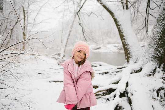girl poses in snowy woods