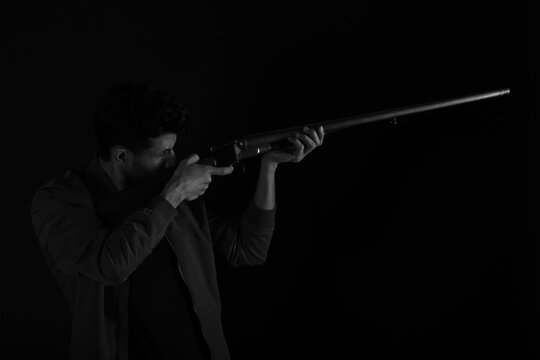 A man with old rifle in black and white